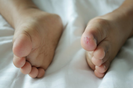 close up of dry child feet on bed ,の写真素材