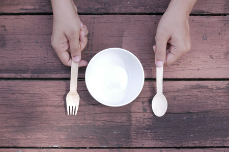 cutlery and empty plate on wooden background top downの写真素材