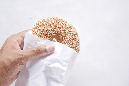 fresh bagel bread in a paper on tableの写真素材