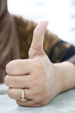 adhesive bandage on hand close upの写真素材