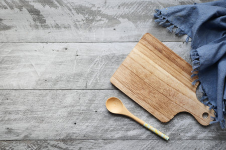 wooden chopping board on wooden background top down