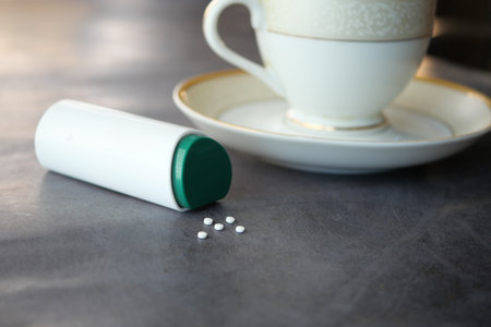 artificial sweetener and tea cup container on tableの写真素材