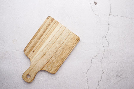 wooden chopping board on white background top downの写真素材