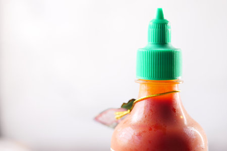 chili and tomato sauce in a small jar on tableの写真素材