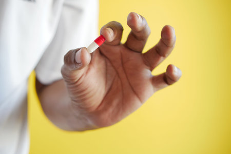 men holding a red and yellow color capsule