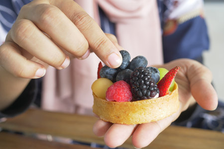 women eating berry fruit tartの写真素材