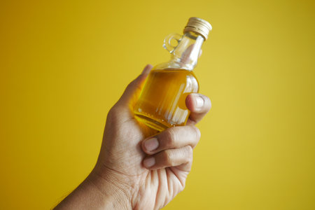 hand holding a bottle of olive oilの写真素材