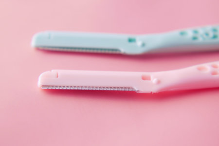 color plastics woman razors and shaving blade on table