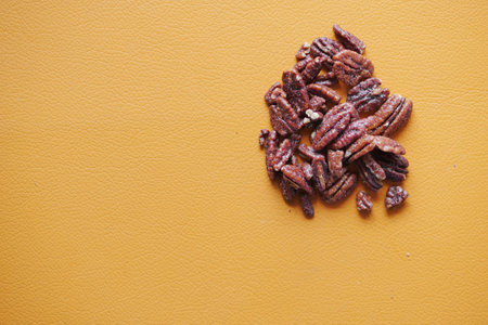 Tasty pecan-nut on a wooden board on orange color tableの写真素材