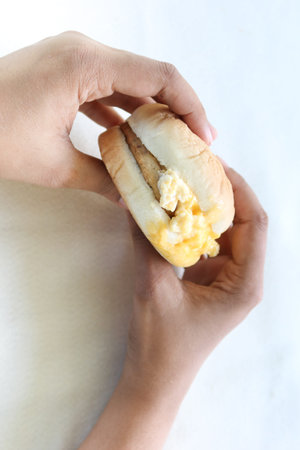 women hand holding beef burger top view