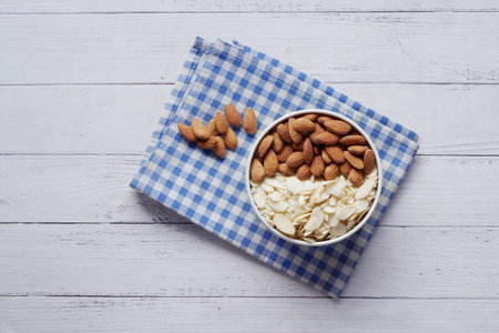 top view of almond nut and slice in a bowl on tableの写真素材