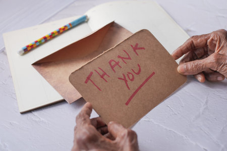 senior womens hand holding thank you letter , rear viewの写真素材