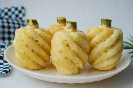 slice of pineapple in bowl on tableの写真素材