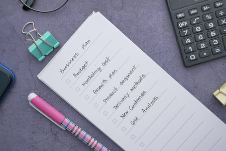 tick mark on business planning goals on notepad