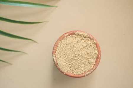 The wooden bowl with rehydrated henna on tableの写真素材