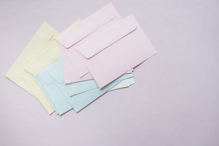 colorful envelope on pink background with copy space.の写真素材