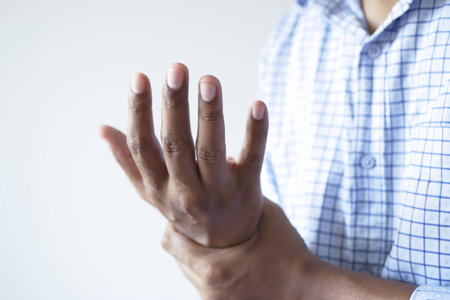 man suffering pain in hand close up