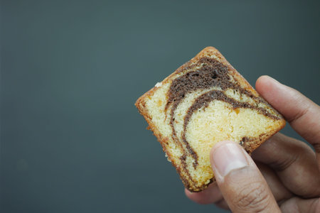 holding a slice of bakery cakeの写真素材