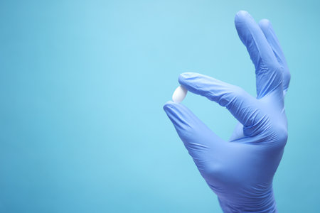 single medical pills on palm of hand , top viewの写真素材