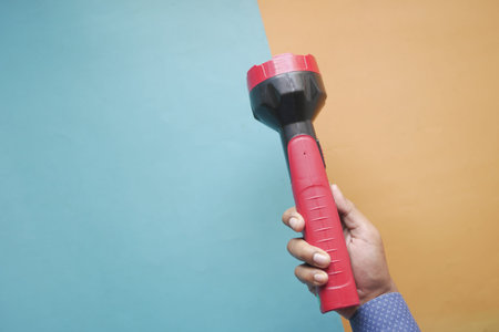 hand holding a tourch light close upの写真素材