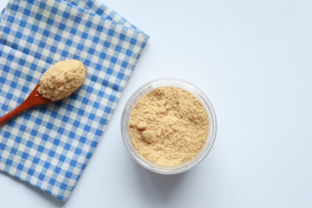 coconut sugar in a container on white backgroundの写真素材