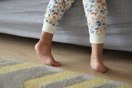 low angle view of A child walking on tiptoes
