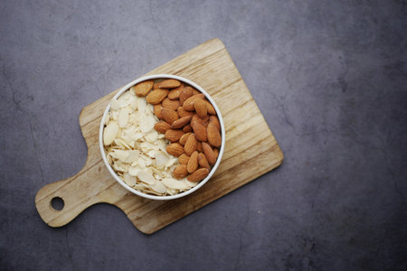 top view of almond nut and slice in a bowl on tableの写真素材