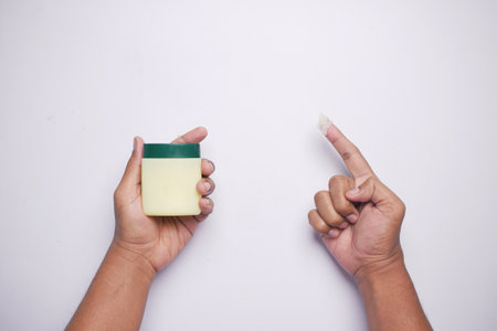 Close up of man hand using petroleum jellyの写真素材