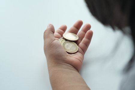 child girl pile coin for saving. sitting on floorの写真素材