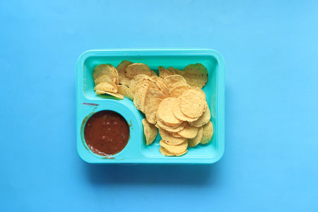 a bowl of chips and salsa on table ,