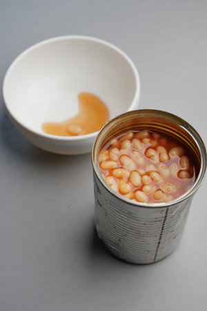 preserved canned tomato beans pouring into a bowl