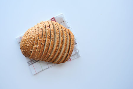 top view of slice of whole grain bread on white background