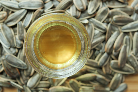 sunflower oil seed and oil in a container on tableの写真素材