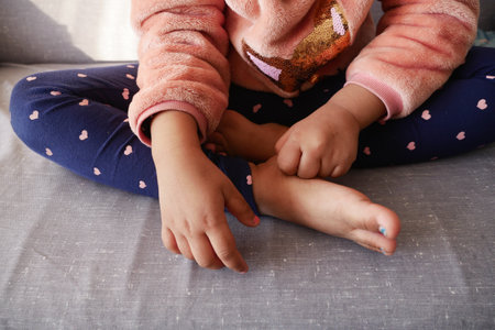 child girl suffering from itching skin, close up.の写真素材