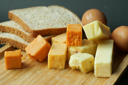 Cheese cubes green, yellow and red color on chopping board