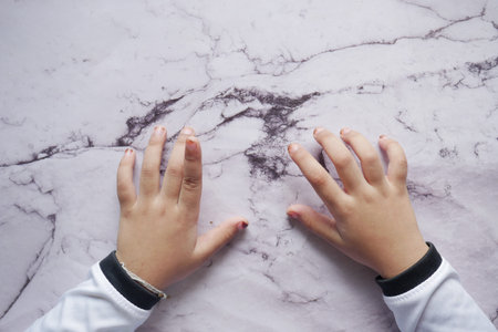 top view of baby hand on tableの写真素材