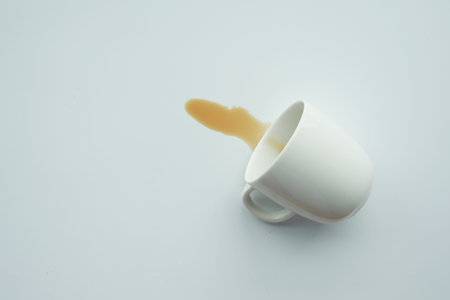 cup of coffee spilled on whiteの写真素材