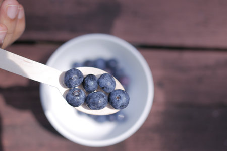 top view of fresh blue berry on a spoonの写真素材