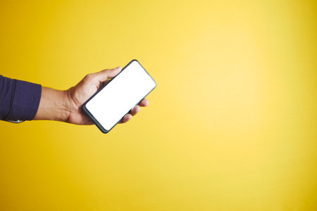 young man hand holding smart phone with empty screenの写真素材