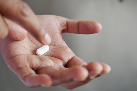 Close up of man hand holding pills with copy spaceの写真素材