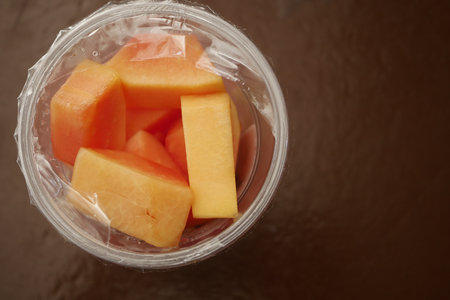 fresh papaya in a plastic containerの写真素材