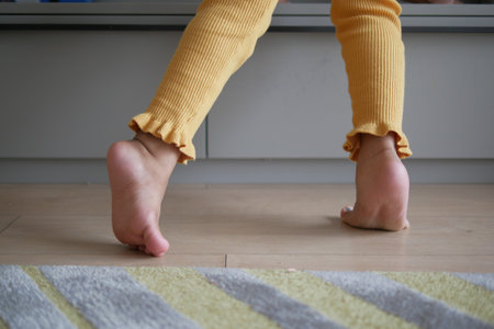 low angle view of A child walking on tiptoesの写真素材