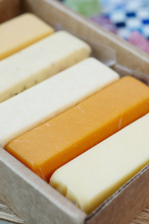 Cheese cubes green, yellow and red color on chopping board