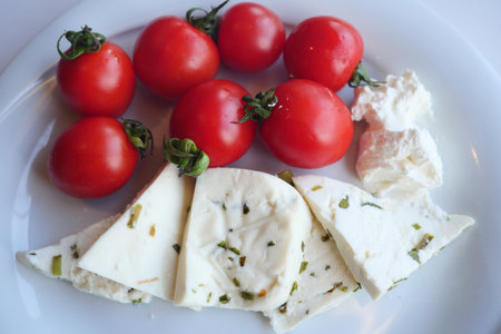 fresh tomato and cheese on tableの写真素材