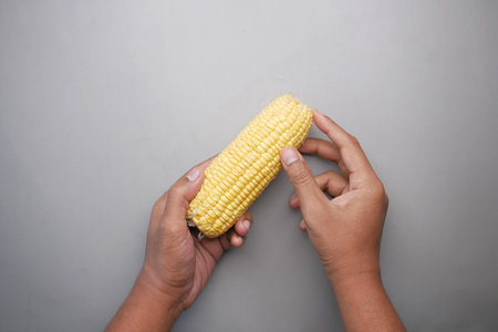 men holding a corn cobの写真素材