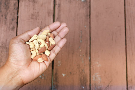 top view of many mixed nuts on handの写真素材