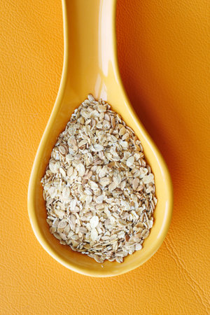 roasted oats flakes spilling on tableの写真素材