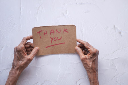 senior womens hand holding thank you letter , rear viewの写真素材
