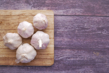 top view of garlic on a chopping board on tableの写真素材