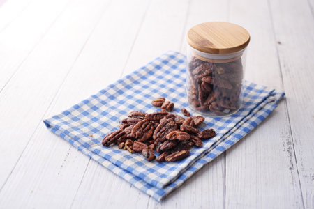 Tasty pecan-nut on a wooden board on white color table